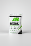 A stand-up pouch of AminoBae Betaine Anhydrous powder supplement. The packaging is white with a large green geometric 'AB' logo, black text, and green accents, with a small photo of white powder in a spoon at the bottom right.
